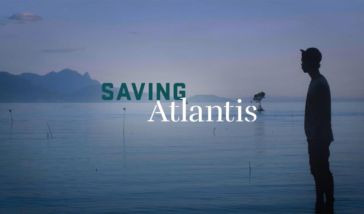 A silhouette of a person standing in a pond, with "Saving Atlantis" title in middle of photo.