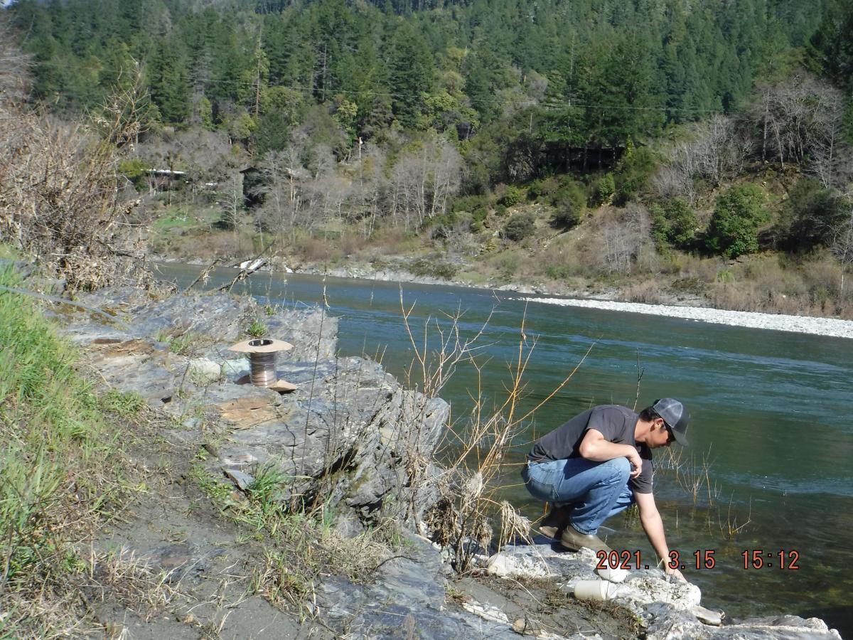 Scientist sampling water from river