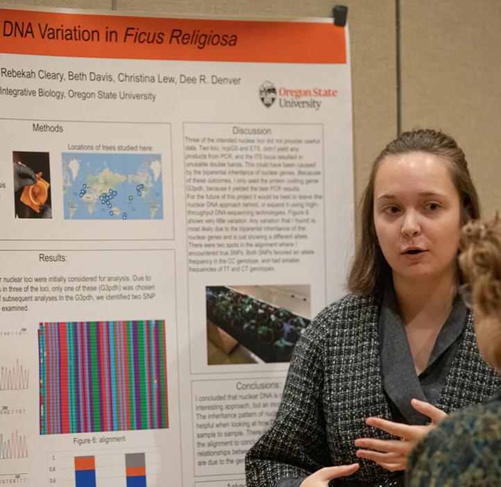 female student showing faculty her research poster